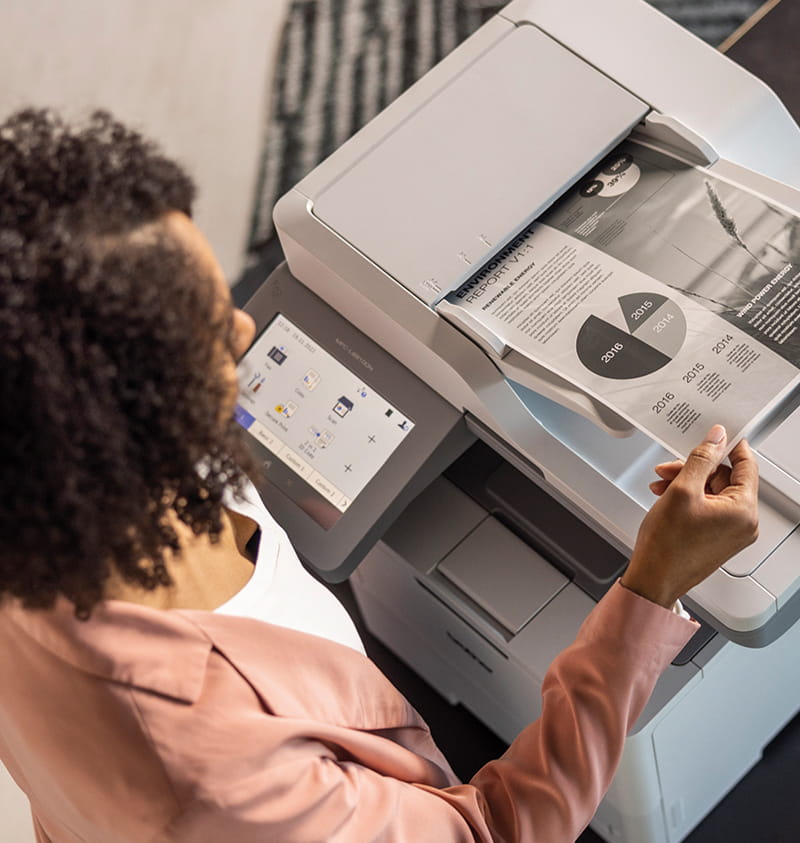 A woman operates a Canon MFC-J5500W printer, demonstrating its features and functionality in a well-lit office environment. Brother Gulf, Middle East & Africa